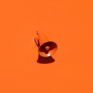 orange megaphone on orange wall